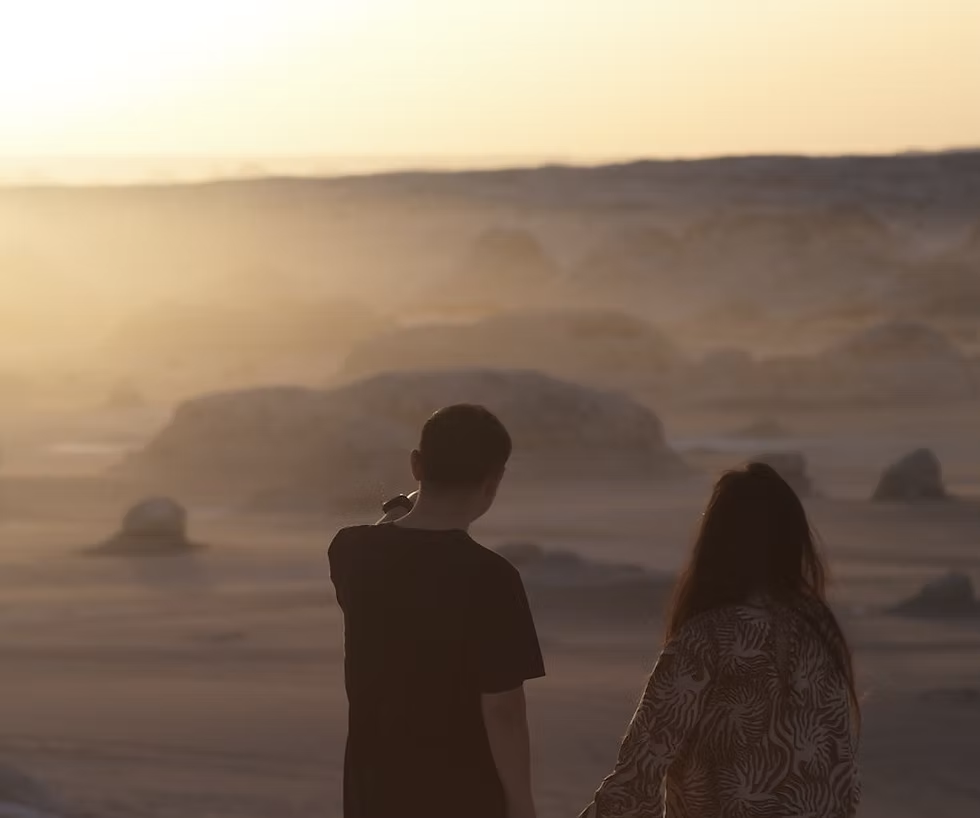 Couple looking at sunset on a beach